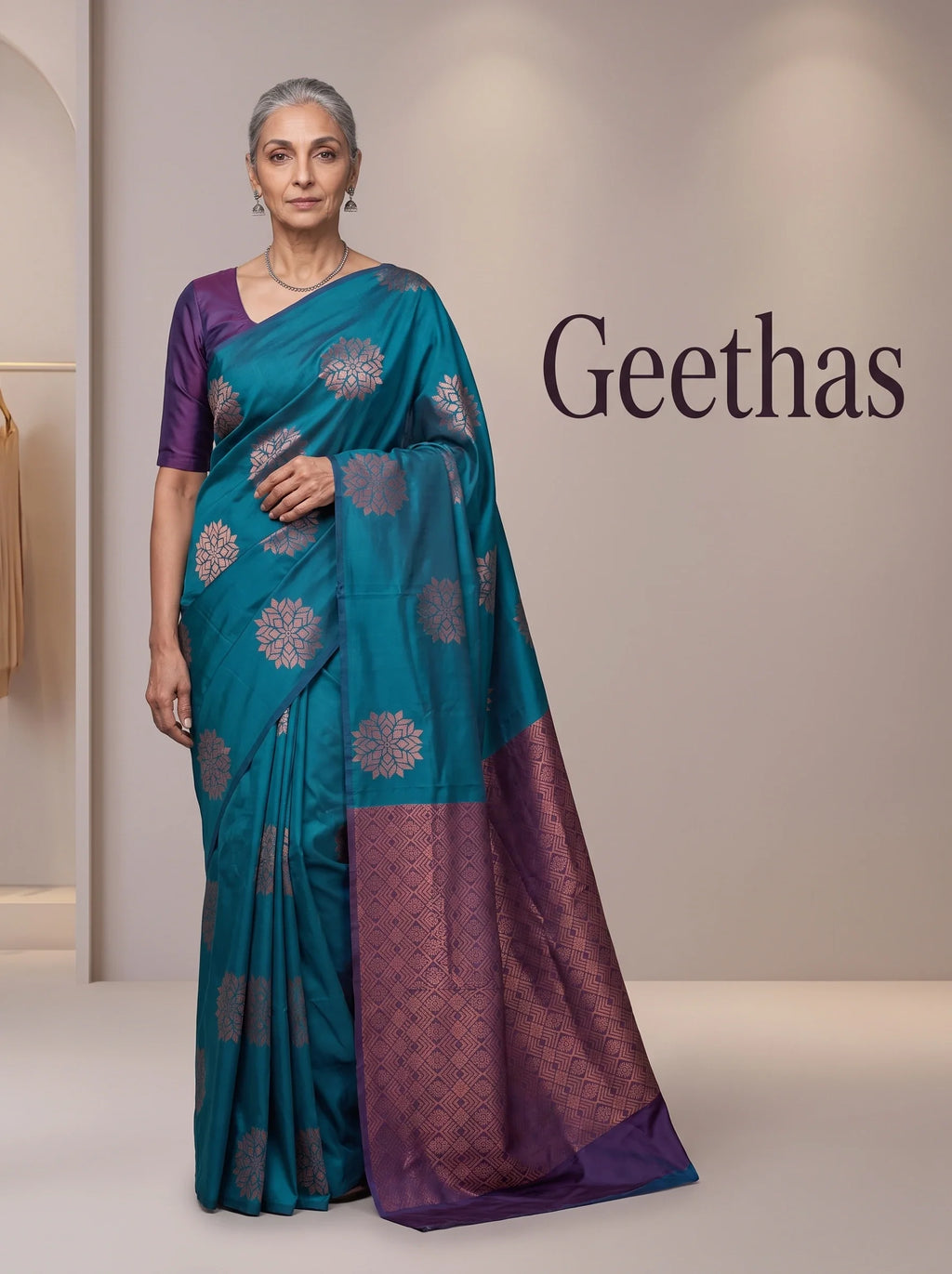 Model wearing teal blue soft silk saree with woven motifs and a contrast deep purple geometric pallu