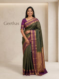 Model wearing a deep green soft silk saree with a purple contrast border and woven gold-toned detailing