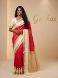Model wearing a bright pink and ivory soft silk saree with gold-toned woven border