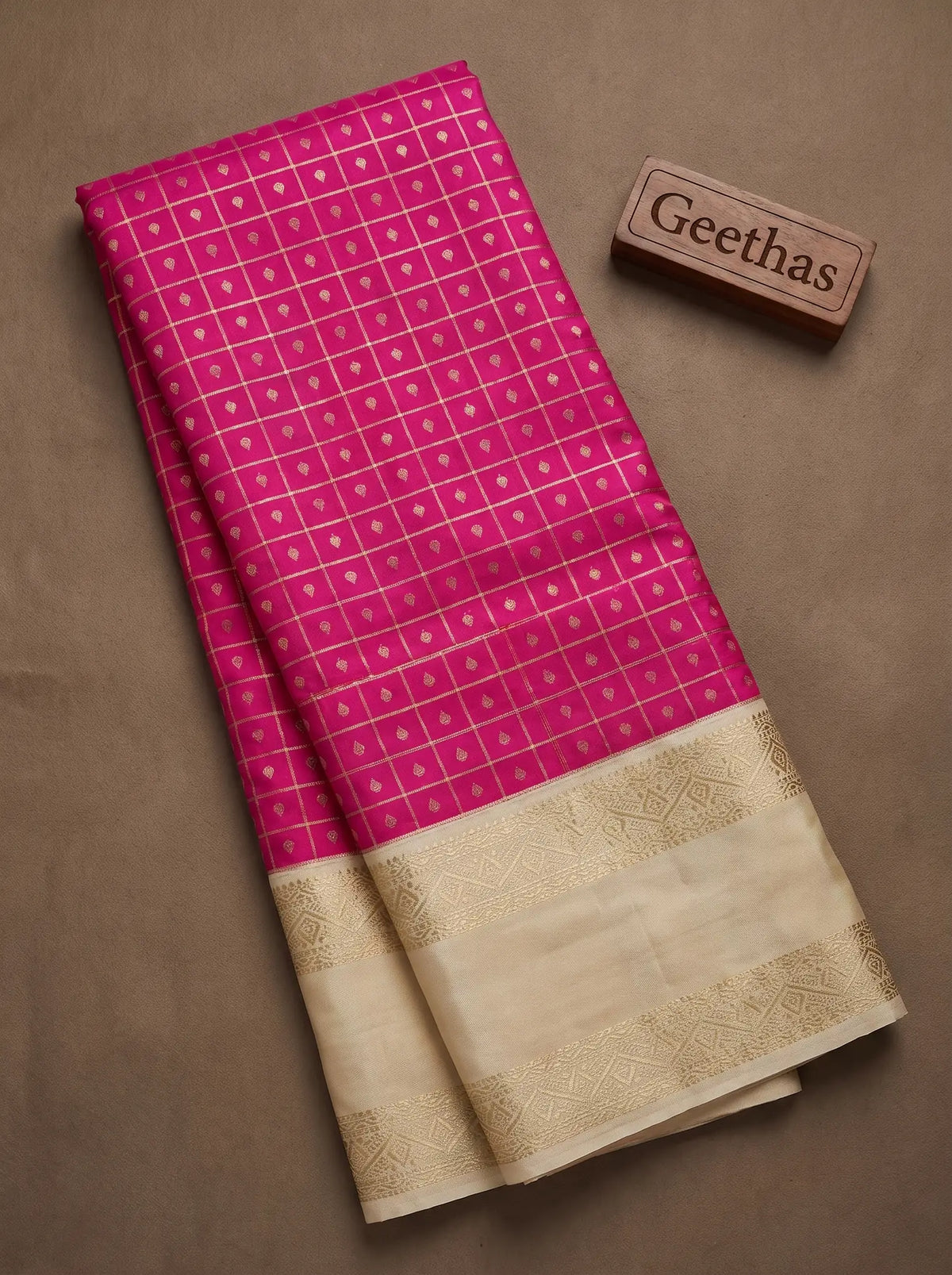 Fuchsia pink soft silk saree with fine gold-toned checks and ivory-gold woven border