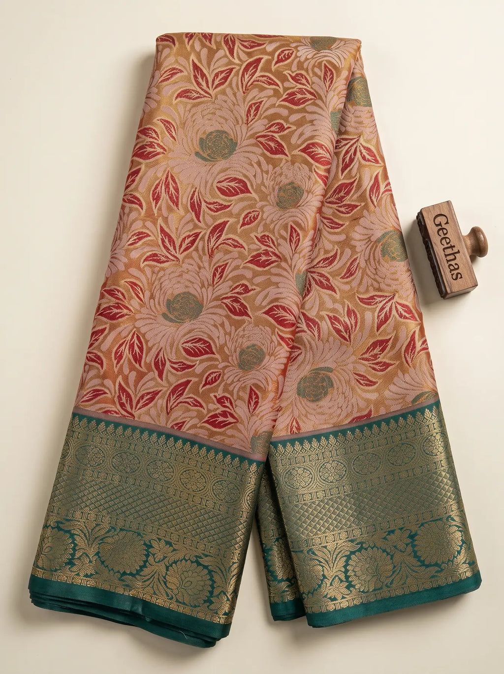Rose red soft silk saree with large woven floral motifs and teal green gold-toned woven border